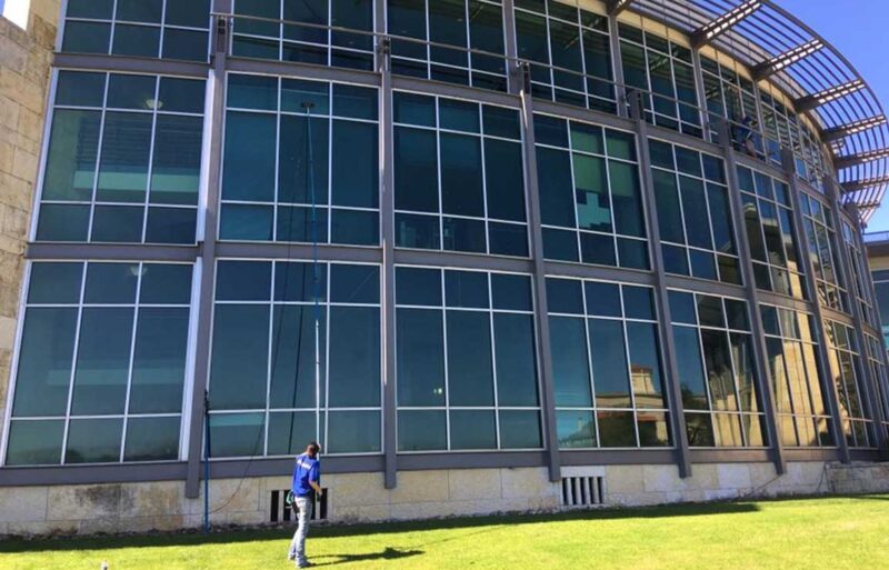 man window washing a commercial building