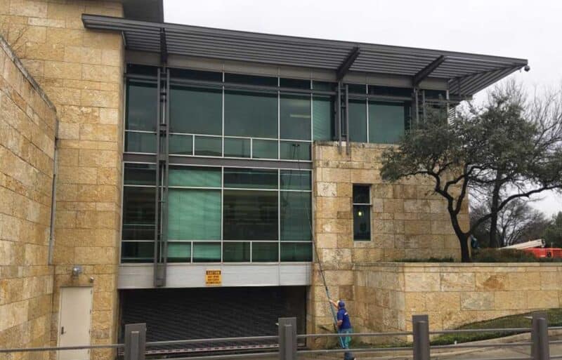 man window washing a commercial building