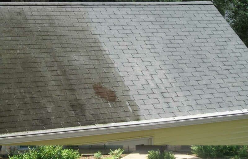 home roof that is half clean and half dirty with stains on it