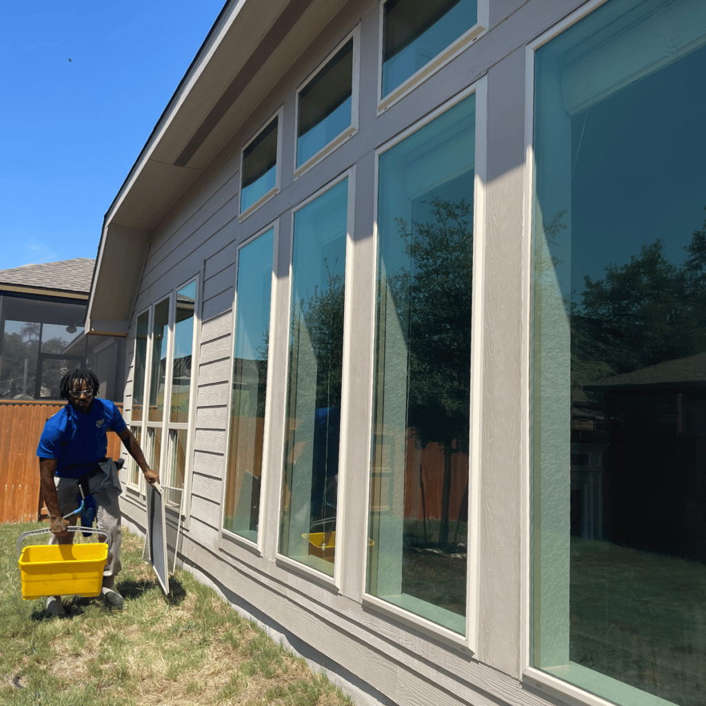 gleam team member cleaning home windows