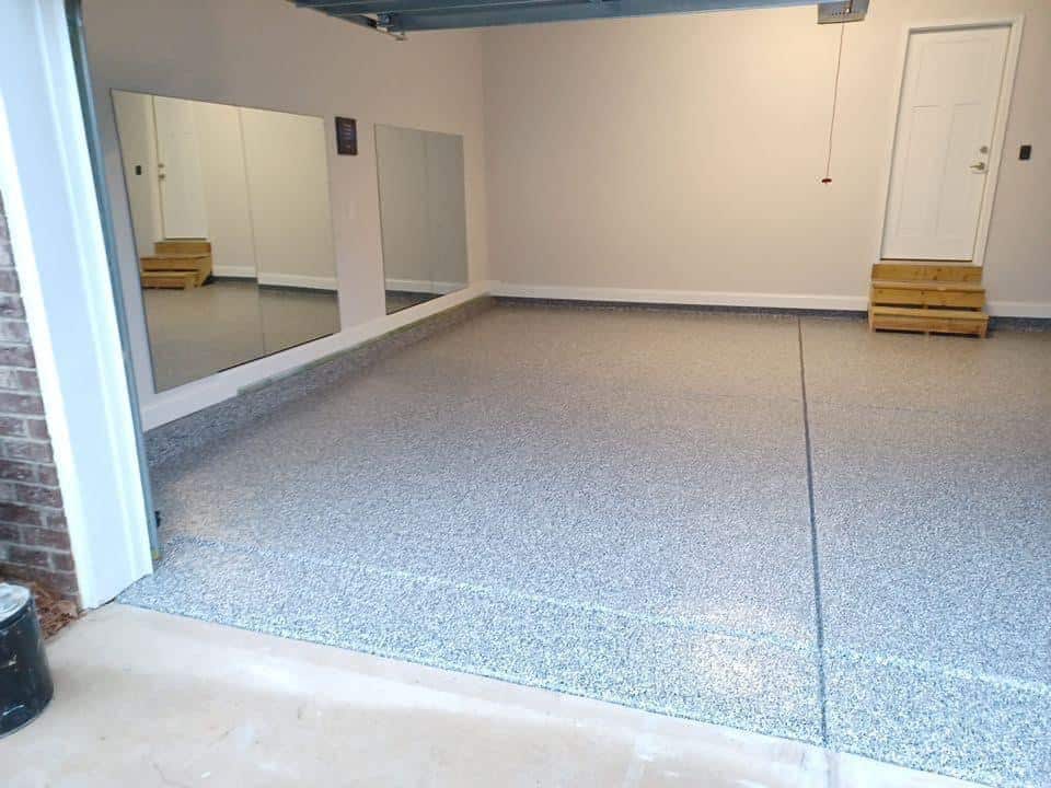 empty garage showing the way garage floor coating looks after services from gleam team